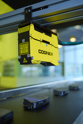 Cognex In-Sight L38 yellow 3D vision system installed above a production line